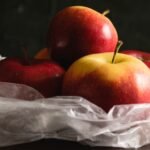 Delicious apples in a plastic bag. Earth day and waste recycling concept