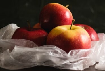 Delicious apples in a plastic bag. Earth day and waste recycling concept