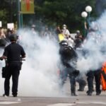 Denver settles protest lawsuits by men injured by police projectiles