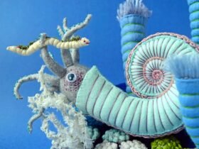 a detail of a plush blue ammonite and worm