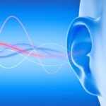 Illustration of ear with sound waves on blue background