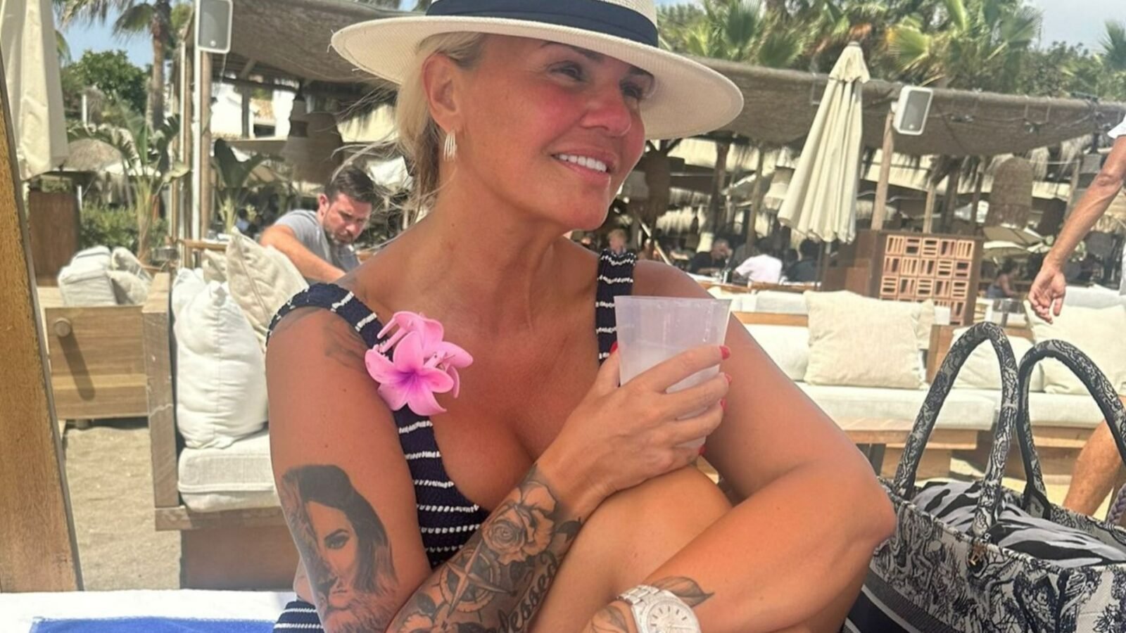 Kerry Katona shows off a huge €24,000 Rolex as she strips down to a bikini to sunbathe on holiday