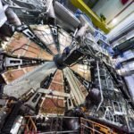 The 100-tonne wheel is lowered 80 meters underground in the ATLAS cavern at the Large Hadron Collider level.