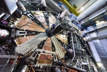 The 100-tonne wheel is lowered 80 meters underground in the ATLAS cavern at the Large Hadron Collider level.