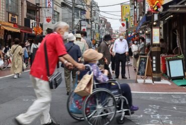 Older adults stroll at a crowded shopping street in Tokyo's Sugamo district