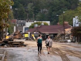 Women walk in the Biltmore Village in the aftermath of Hurricane Helene