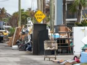 Debris left by Hurricane Helene is piled up in the street