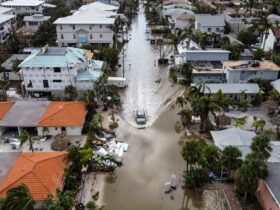 Aerial of car droving through flooded street