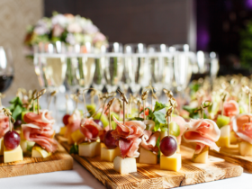 A catering table with Champagne, wine and finger foods