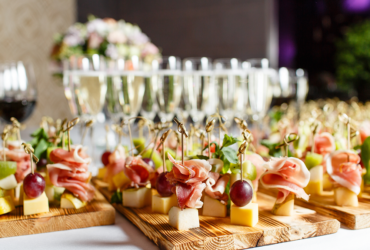 A catering table with Champagne, wine and finger foods