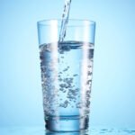 water being poured into a clear glass