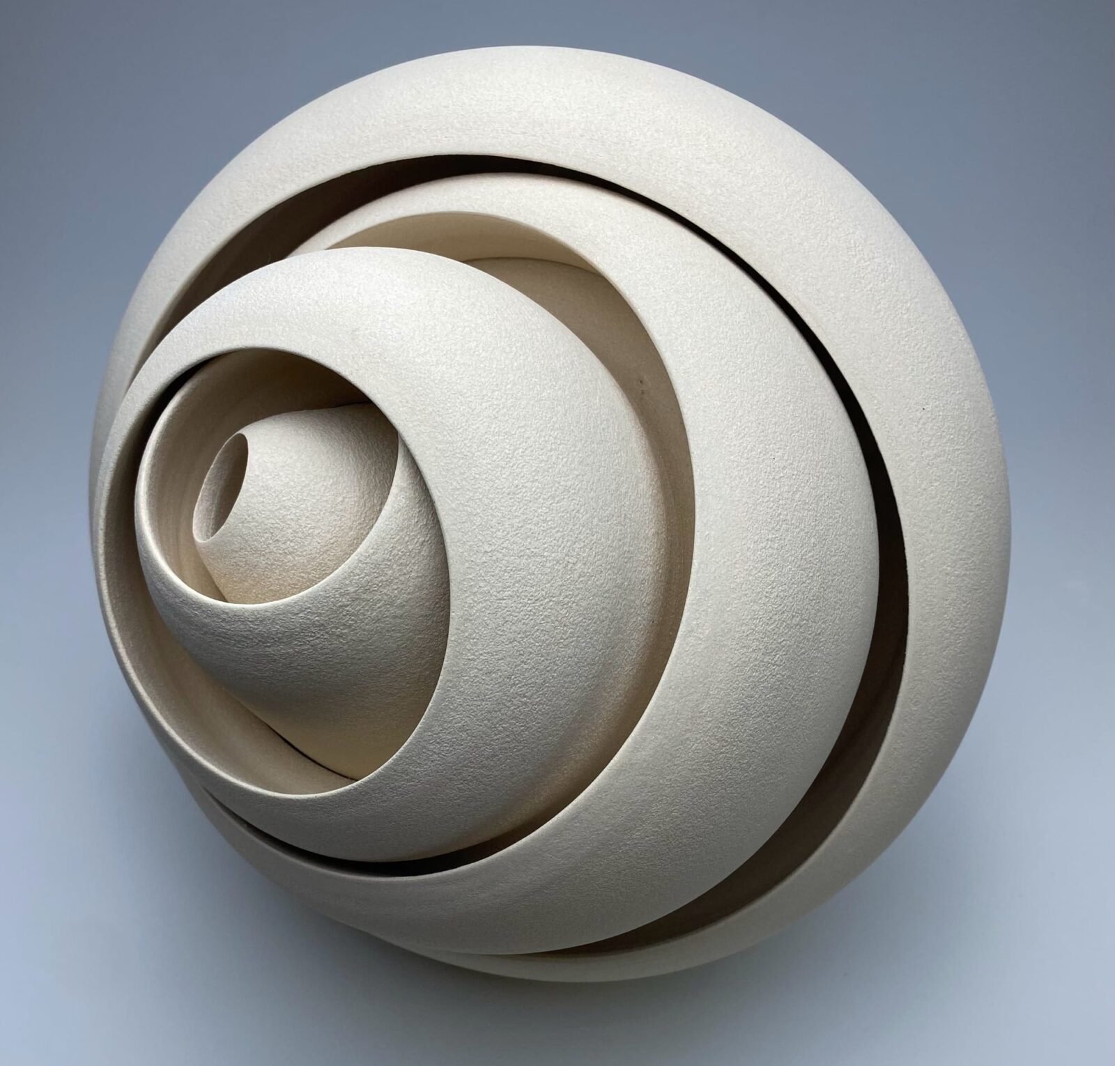 a ceramic sculpture with concentric forms that twist and well outward