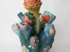 an abstract, colorful ceramic sculpture with nature-inspired elements evocative of coral or flowers