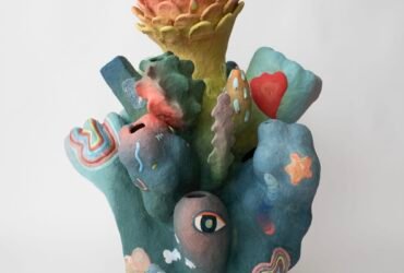 an abstract, colorful ceramic sculpture with nature-inspired elements evocative of coral or flowers