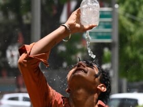 A boy in India pours water over his head.
