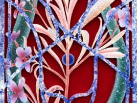 the side view of a painting on wood and velvet of otherworldly pink and purple flowers behind an ornate barrier reminiscent of wrought iron