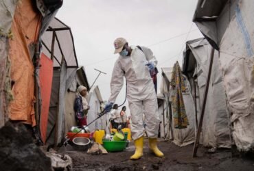 A worker spraying chlorine in Goma in the Democratic Republic of the Congo in August 2024