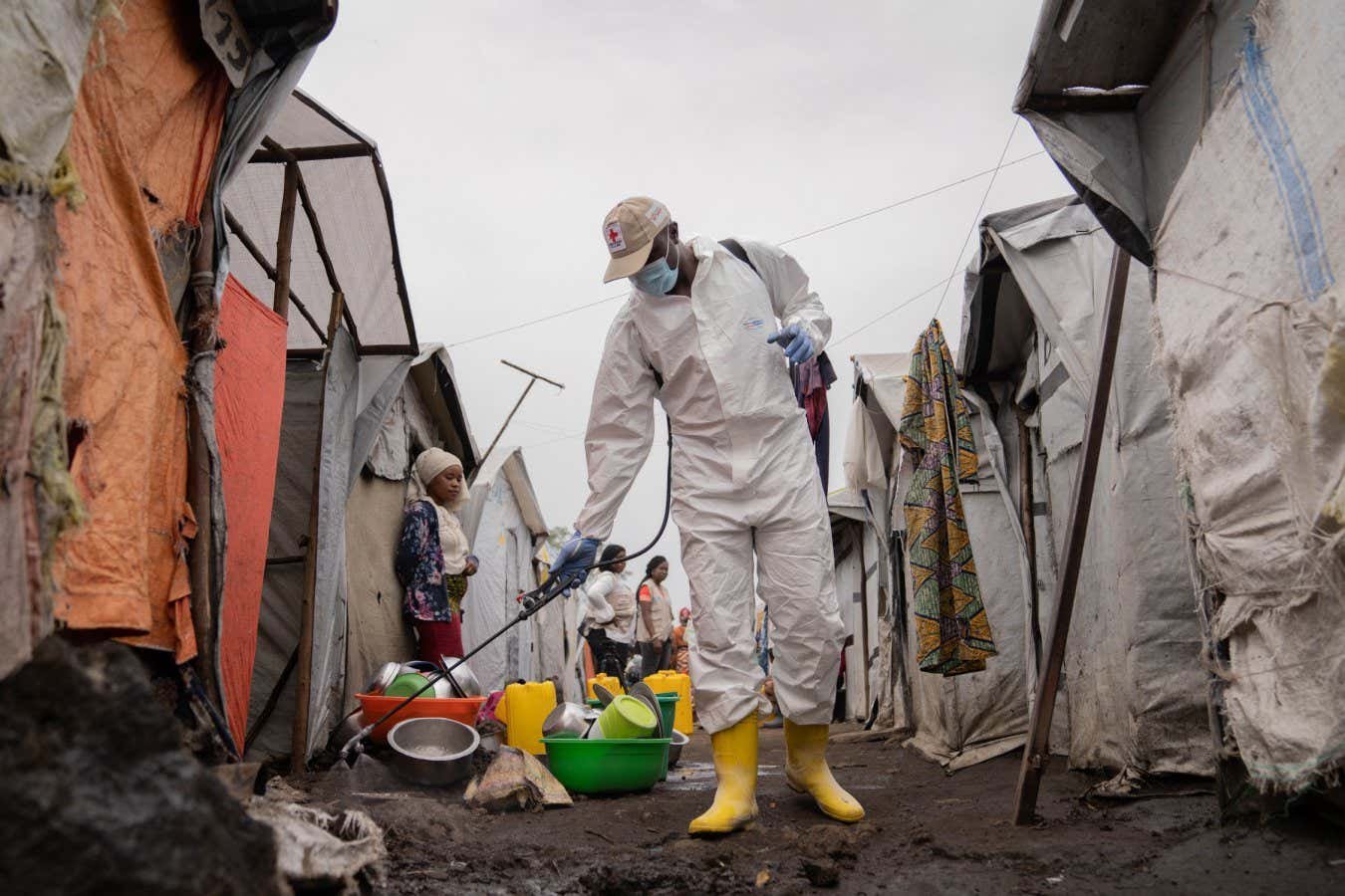 A worker spraying chlorine in Goma in the Democratic Republic of the Congo in August 2024