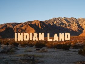 a large-scale installation in the desert resembling the Hollywood sign that reads "INDIAN LAND"