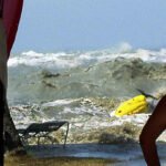 A tsunami approaches people on a coastline in Malaysia on December 26, 2004.