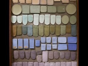 a tray of various shapes of ceramic pieces glazed with different colors