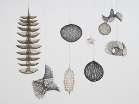 an installation view of abstract crocheted wire sculptures by Ruth Asawa