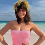 Helena Christensen, 56, looks stunning in a pink swimsuit and seaweed crown