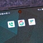 android phone with app logos Google, Google Voice, Google Fi