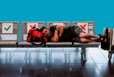 A traveller sleeps on a bench with a suitcase at Cyprus