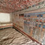 the interior of a kiln tomb in Saqqara of a doctor named Tetinebefou, with brightly colored walls and relief carvings in stone