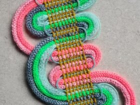 vibrant textured fibers woven in the style of passementerie while incorporating geometric, curving forms