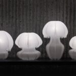 four white jellyfish-like lamps made of white knitted plastic