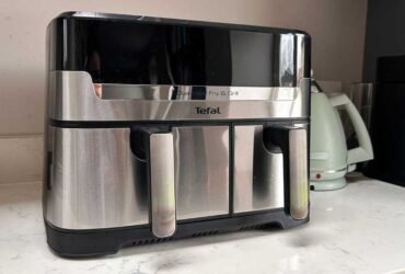 The air fryer on a kitchen counter, with a kettle in the background