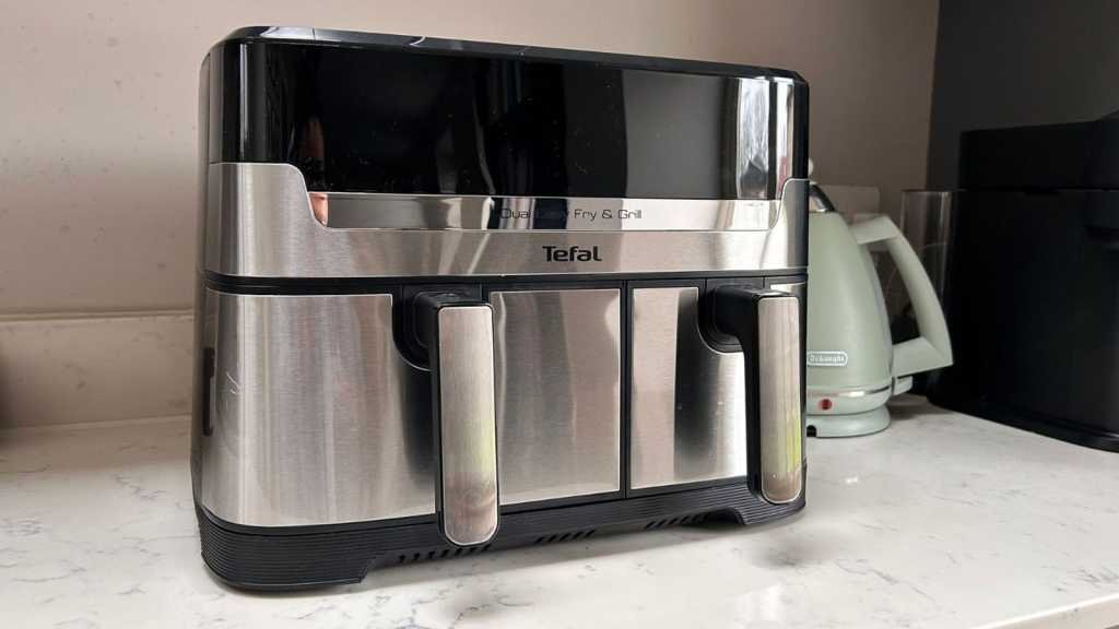 The air fryer on a kitchen counter, with a kettle in the background