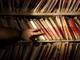 tons of medical records on a shelf in a darkened room