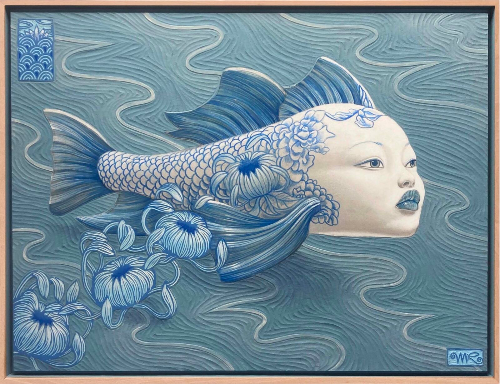 a combination woodcut and acrylic painting of a blue fish with the face of a human woman, with blue flowers falling from its back as it floats atop the surface of the water