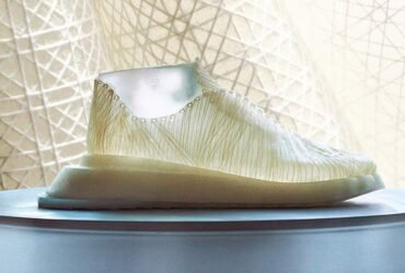 A shoe made of nanocellulose sits in front of a curtain.