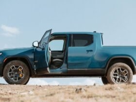 Blue Rivian R1T side view, driver door open