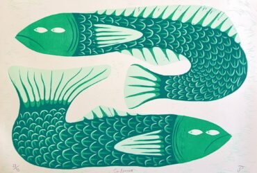 a woodblock print of two green fish facing in different directions