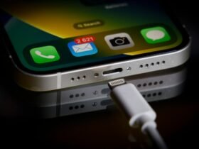 A Apple Lightning port charging cable is seen with with an iPhone in this illustration photo in Warsaw, Poland on 05 October, 2022.