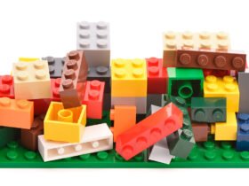A pile of multi-colored legos, some stacked, some jumbled haphazardly. The image illustrates a book review of Memory Lane by Ciara Greene and Gillian Murphy.