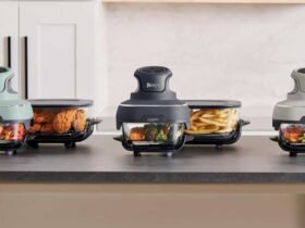 The portable air fryer in three different colours on a counter