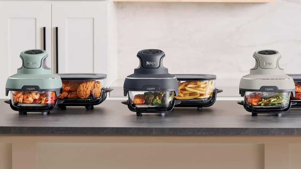 The portable air fryer in three different colours on a counter