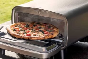 Pizza being removed from the Artisan oven