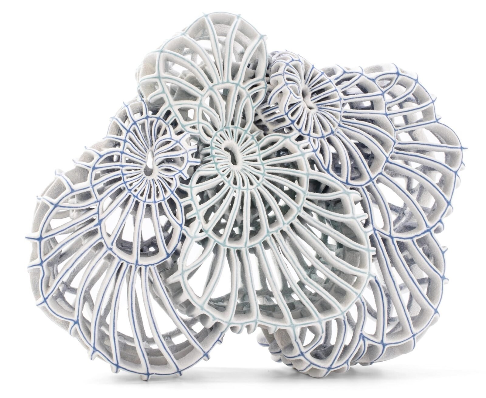 an abstract ceramic sculpture with blue porcelain and white flocked-like surfaces with numerous spokes and irregular concentric circles