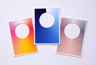 three postcards with holes in the center