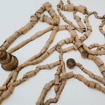 Sprawling sculpture made of cardboard roles meant to look like wood or ant hills and the tunnels that connect them.