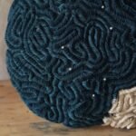 a detail of a sculpture made of tightly meandering textile, resembling coral