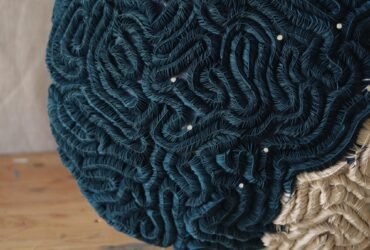 a detail of a sculpture made of tightly meandering textile, resembling coral