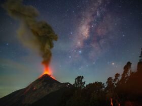 a volcano erupts beneath the milky way